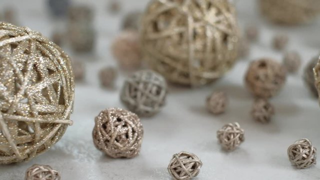 Christmas composition. Golden vine balls. 4K resolution trucking shot. Shallow depth of field.