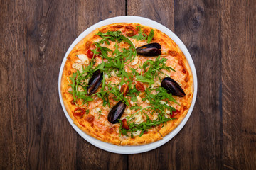 classic Italian pizza with mussels on a wooden table