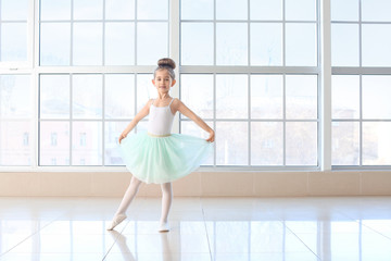 Cute little ballerina in dance studio