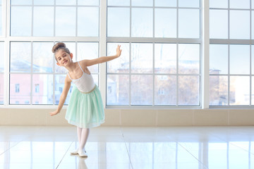 Fototapeta na wymiar Cute little ballerina in dance studio