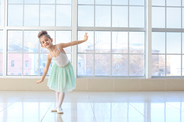 Cute little ballerina in dance studio