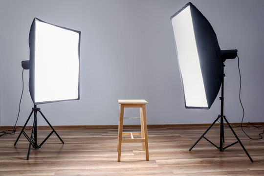 Chair and lighting equipment in modern photo studio