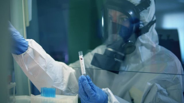 Female researcher works in laboratory with coronavirus samples.
