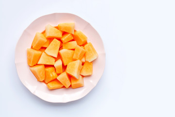 Sliced melon in dish on white background.