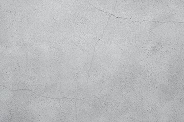 ヒビの入った淡いコンクリートの壁