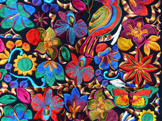 Close up of сolorful embroidered decorative textile and pillows at the artisan's market in...