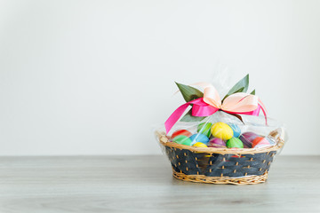 Fototapeta na wymiar Easter color eggs in festive gift basket