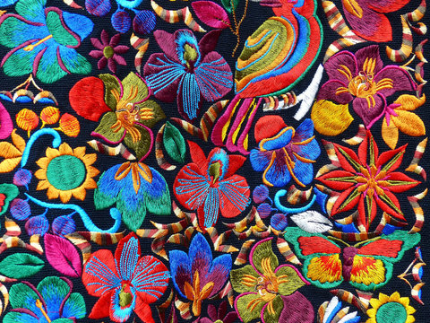 Close up of сolorful embroidered decorative textile and pillows at the artisan's market in Otavalo, Ecuador	
