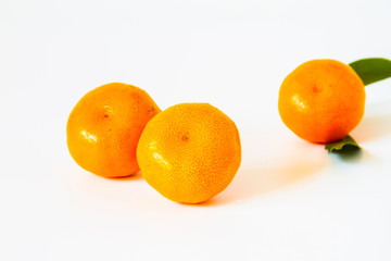 Tangerine Orange or clementine with green leaf isolated on white background
