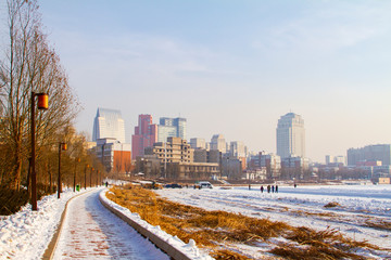 Lake side walk trail and China city of Changchun landscape in winter Nanhu park