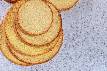 Sliced soft cake on table for making wedding cake.