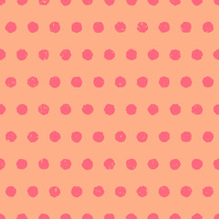 Pink textured polka dot background. Cute seamless pattern with pink circles on orange background.