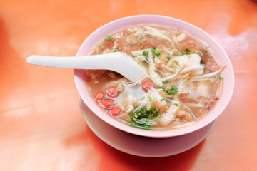 Bone marrow soup also known as soup gear box.served in a pink bowl.