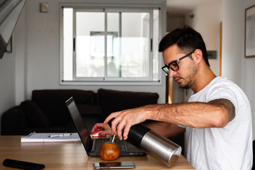 young man telecommuting from home