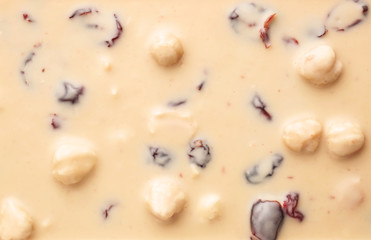 Sweet white chocolate with nuts as background