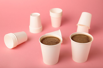 Takeaway coffee cups on color background