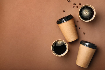 Takeaway coffee cups on color background