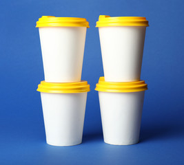Takeaway coffee cups on color background