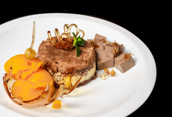 desserts on black background in white plate