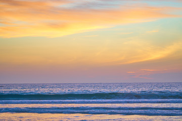 Incredibly colorful sunset on the tropical beach. Abstract nature background.