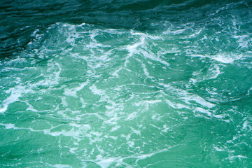 Fototapeta na wymiar Waves on the green ocean water. Abstract nature background.