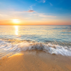 Fototapeta premium Beautiful minimalist beach, waves and sunset sky for background