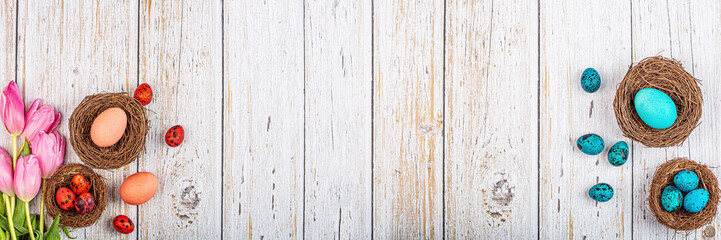Stylish background with easter eggs with copy space for text on white wooden background. Horizontal banner for web design. Flat lay, top view, mockup, overhead, template