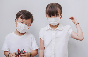 Twin little boy and girl wearing mask protect from virus and air pollution go to school....
