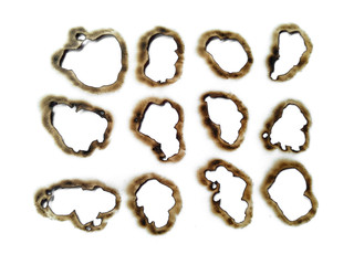 Collection of burnt holes in a piece of paper isolated on white background. Fire holes in white paper.