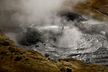 Beautiful colourful Icelandic landscape lava fields mountain geysers zigzag road and moss-covered stones Namafjall, Iceland.