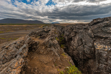 Fototapeta na wymiar Beautiful colourful Icelandic landscape lava fields mountain geysers zigzag road and moss-covered stones Namafjall, Iceland.