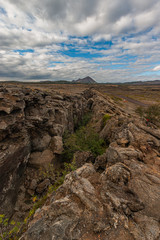 Beautiful colourful Icelandic landscape lava fields mountain geysers zigzag road and moss-covered stones Namafjall, Iceland.