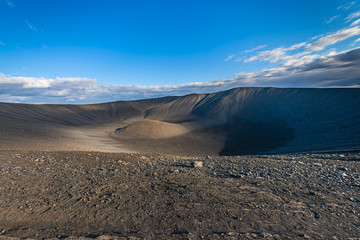 Beautiful colourful Icelandic landscape lava fields mountain geysers zigzag road and moss-covered stones Namafjall, Iceland.