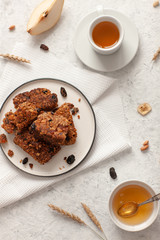 Breakfast with granola, tea and fruit on white wooden background top view mock up.