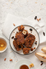 Breakfast with granola, tea and fruit on white wooden background top view mock up.