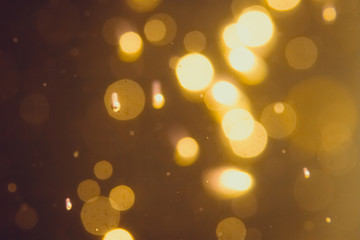 Dark Abstract Gold bokeh sparkle on black background