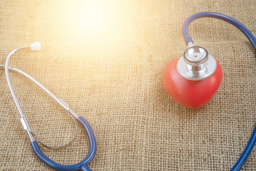 Stethoscope and red heart for check health isolate on white