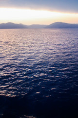 Corfu island beaches, waterfront, sea, bay, view from a ferry, beautiful sunset, Greece