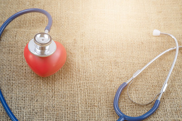 Stethoscope and red heart for check health isolate on white
