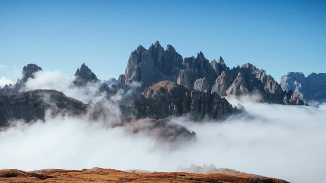 Looks like a heaven. The peaks of the mountains stifle from a going thick fog. Unbelievable photo takes.