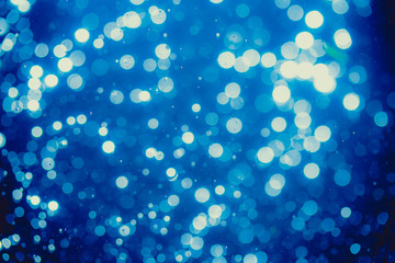 Abstract blue defocused bokeh of lights in dark