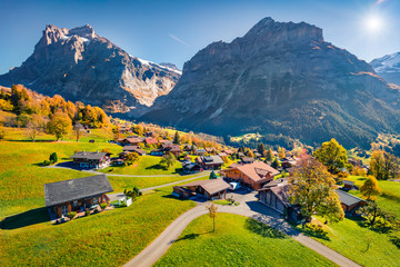Aerial autumn view of Grindelwald village valley from cableway. Wetterhorn and Wellhorn mountains,...