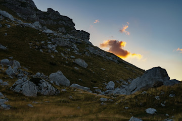 View of the sun-drenched cloud in summer in the mountains of Durmitor Montenegro Park