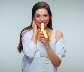 Happy woman eating banana. isolated female portrait.