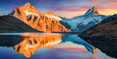 Awesome evening panorama of Bachalp lake (Bachalpsee), Switzerland. Unbelievable autumn sunset in...