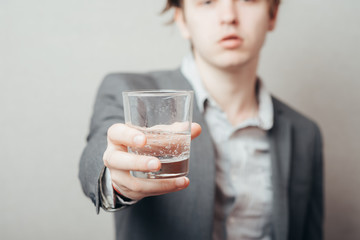 Casual businessman holding glass of water