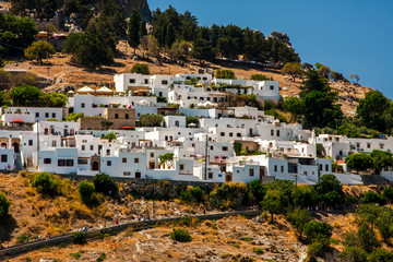 Ancient greek white houses on a rocky shore