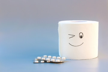 Toilet paper and pills. Concept of hemorrhoid treatment.