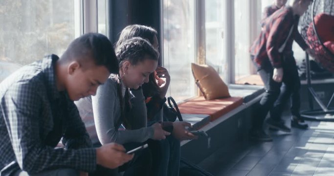 Girls watching a bully teasing boy