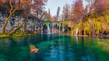 Last warm autumn days in Plitvice National Park. Picturesque autumn scene of pure water lake and waterfalls in Croatia, Europe. Beauty of nature concept background.